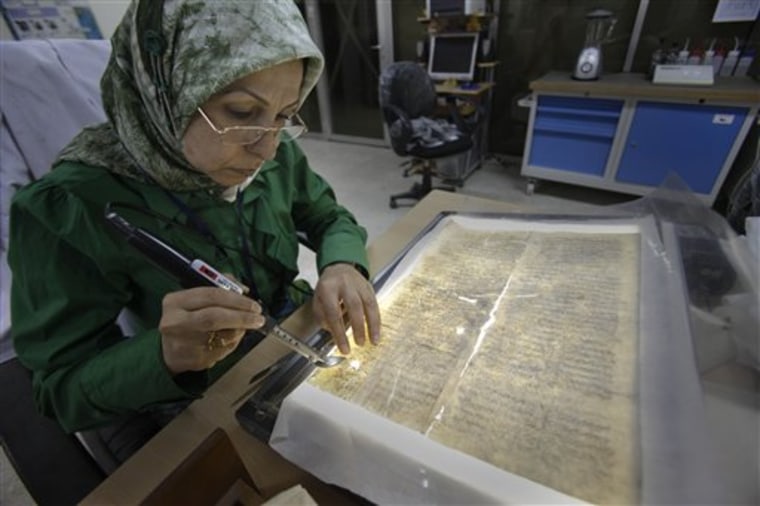 Alaa Jassim, a member of the library restoration staff, works on a damaged document at the Iraq National Library and Archives in Baghdad. A trove of Jewish books and other materials, rescued from a sewage-filled Baghdad basement during the 2003 invasion and now stored at the National Archives and Records Administration in College Park, Md. near Washington, is now caught up in a tug-of-war between the U.S. and Iraq.